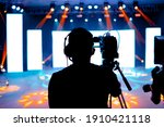 Professional cameraman - covering on event with a video, cameraman silhouette on live studio news, Selective focus