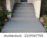 Image example of cement repairs and resurfacing with dark grey acrylic coat finish before sealer application of an exterior concrete staircase.