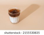 iced black coffee with milk layer in glass
