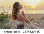 Harmony and balance and concentration, relaxation time at sunset.  A slender woman Feels good and exercises for mindfulness.