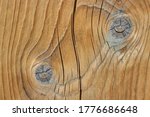 Texture of a wooden board with knots and a crack
