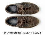 Worn vintage brown leather boots isolated on white background