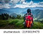 Small photo of September 16th 2021 Uttarakhand INDIA. A solo hiker Hikers with a backpack looking towards the valley of Mountains. Nag Tibba trek of Lower Himalayas.