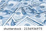 Small photo of American paper money. 100 dollar and other US notes. Light blue tinted wallpaper or background. Savings economy and the USA dollar. National debt and Treasury
