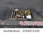 Small photo of trash blocking storm drain gutter