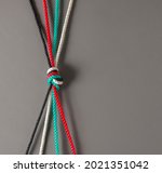 Small photo of Conceptual photo for 'unity' of Emirati citizens. UAE flag color ropes tied together to connote 'strength' and 'togetherness'.