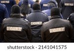 Small photo of Police officers are seen from their backs. Unrecognizable policemen and policewomen. Gendarmery.
