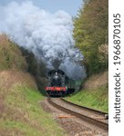 Small photo of Ropley, Hampshire, UK May 2021 GWR Prairie tank engine 5526 climbing up the bank towards Ropley pass the fixed distant near Northfield Crossing.