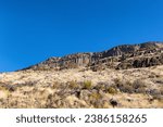 Small photo of Rimrock cliffs made of basalt rock is a familiar sight along highway 26 near Warms springs in eastern Oregon.