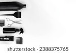 Small photo of Professional items for a hairdressers, haircuts on a white background. Composition with scissors, other hairdresser's accessories on white background. Professional hairdresser's accessories