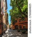 Small photo of Stockholm/Sweden - May 31th 2020 - A view on an almost empty street, Sjalagardsgatan and Branda Tomten, very cozy and moody place in the Old Town during the pandemic outbreak of coronavirus.