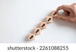Small photo of Business growth concept, male hands arranged stacked wooden blocks steps on white table, future business growth arrow, development to achieve goals, copy space.