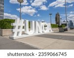 Small photo of New York, New York, USA - Aug 2, 2023: The hashtag of the United Nations General Assembly (UNGA) is on display outside the UN Headquarters in New York City, USA.