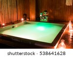 private romantic in jacuzzi in luxury health spa in resort. High ISO image. ambiental light only.