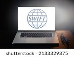 SWIFT logo on laptop screen.