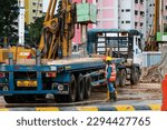 Small photo of SINGAPORE - 9 APR 2023: Migrant workers from South Asia at a construction site in Ang Mo Kio town. The construction industry is highly dependent on migrant workers as locals shun such jobs.