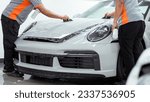Small photo of Abu Dhabi, United Arab Emirates - July 25th, 2023 - Photo of a PPF technicians applying PPF on bonnet of a car- Paint Protection Film
