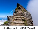 “Miradouro Pedra Rija“ a panoramic view point near „Pico do Arieiro“ peak, Madeira Island portugal. Narrow mountain ridge with steep precipice on both sides of the trail with stone stairway to heaven.