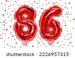 Small photo of The number of the balloon made of red foil, the number eighty-six on a white background with sequins. Birthday greeting card with inscription 86. Numerical digit. Celebration event.