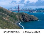 Panoramic view of San Francisco and the Golden Gate Bridge, with the blue Bay in the foreground.