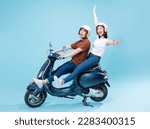 Young Asian couple ride scooter on background