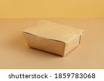 Brown paper food box. Ground color background. Reusable package concept