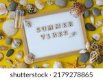Composition sheet white paper text SUMMER VIBES, seashells, pebbles, mockup on yellow background. Blank, top view, still life, flat lay sea vacation travel concept tourism and resorts. Summer holidays