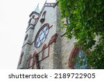 Small photo of Washington, DC US - June 17, 2022: Looking up at facade of Saint Domenic's Catholic Church with round window and bell tower
