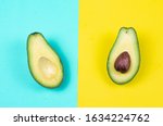 Photo of two slices natural bio organic green avocado on the colorful background solid yellow and solid cyan background 