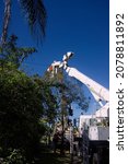 Small photo of Walkerston, Queensland, Australia - 22 July 2021; Electricity power workers or linesmen replacing a damaged electrical supply pole in a suburban street in North Queensland.