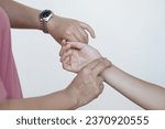 Small photo of Close up woman hand is checking pulse on wrist hand, compare pulse rhythm with watch. Concept, medical health care. Checking heart rate pulse on wrist. Measuring and monitoring sickness of patients.