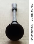 Small photo of Black shawm (schalmei, schalmeien) - an old folk European woodwind musical instrument, with a close-up trumpet and a mouthpiece out of focus