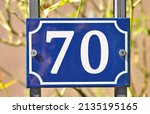 A Blue Colored Number Plaque ...