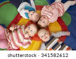 Small photo of Overhead View Of Babies Lying On Mat At Playgroup