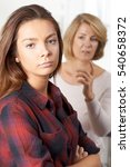 Small photo of Bored Teenage Girl Being Told Off By Mother