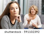 Small photo of Bored Teenage Girl Being Told Off By Mother