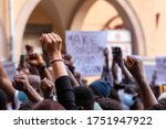 People raising fist with unfocused background in a pacifist protest against racism demanding justice