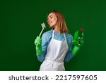 woman in gloves holding brush and bottle of detergent