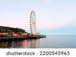 Small photo of Seattle Washington USA - August 29, 2022: Seattle Great Wheel at Sunrise. The Seattle Great Wheel is a giant Ferris wheel at Pier 57 on Elliott Bay in Seattle, Washington.