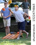 Small photo of June 7, 2014: Brian Corbitt of Catonsville makes a toss during the 5th annual C-Ville Cornhole Challenge
