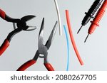 Small photo of nippers, heat shrink tubing and styli electro tester. light background. close-up