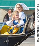 Small photo of STOCKHOLM - JUN 06, 2019: The swedish Madelaine and princess Estelle Bernadotte in a royal coach smiling and waiving to the audience. Stockholm, Sweden June 06, 2019