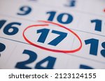 Small photo of Marking the seventeenth 17 day of a month in the calendar with a red marker. Note of the calendar, significant date. Signing the day on the calendar. Reminder mark on the eighteenth 18 day of month.
