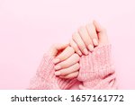 Woman's hands with beautiful manicure on pink background. Hands spa concept