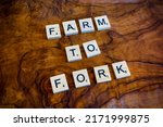 Small photo of Stockholm, Sweden - 26 June 2022: Farm to Fork against vintage wood background as concept for the EU common agricultural policy enacted as regulation and directive