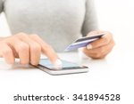 closeup woman hand using phone and credit card shopping online