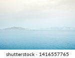 Foggy mountain misty islands covered with fog, calm sea lake landscape background, sunlight in cloudy sky scenery morning weather,