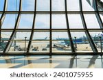 Airport terminal glass window with view of airplane, Suvarnabhumi airport departure hall for travel and transportation concept.