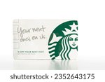 Small photo of Everett WA USA August 4 2023; Starbucks Gift Courtsey Card on a white background