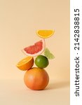 Small photo of Balancing citrus on the table, copy space. Equilibrium floating food balance. Fruit floats on the table: grapefruit, lime, orange.